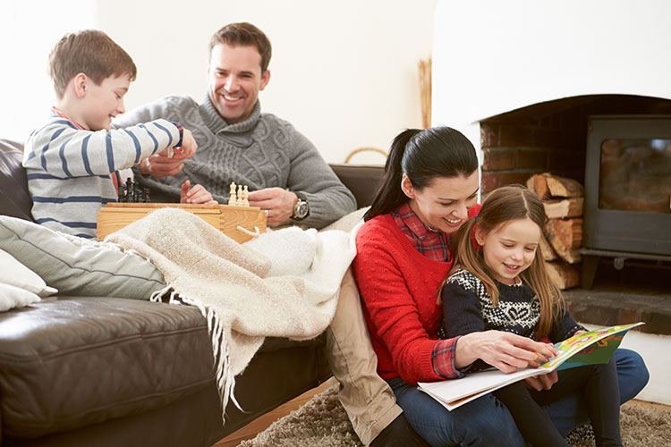 family spending time together in living room by the fireplace