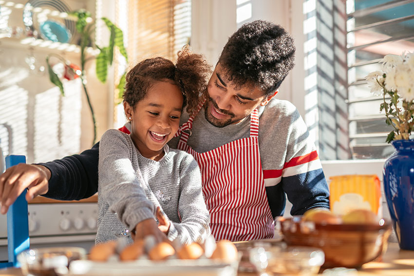 Father and daughter cooking together