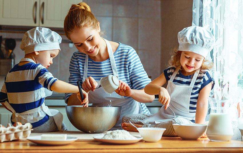 Mom baking with two daughters