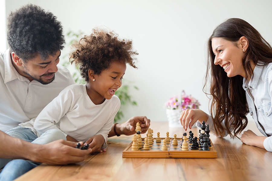 happy family plays chess while boiler heats room