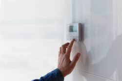 Person setting a thermostat