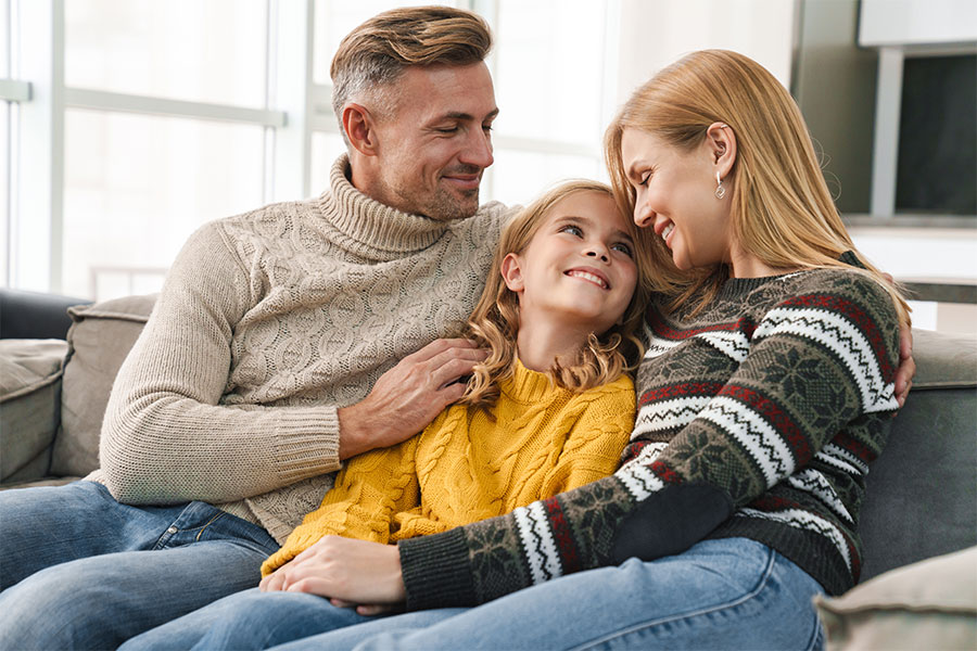 Family sitting in living room comfortably in furnace heated house