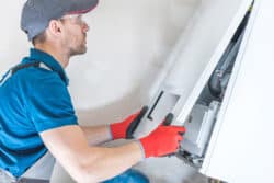 Technician working on heating system repair